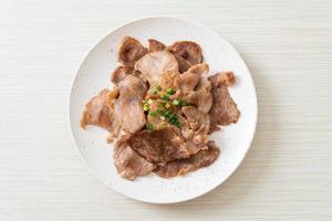 grilled pork neck sliced on plate photo