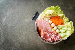 sukiyaki or shabu hot pot black soup with meat raw and vegetable photo