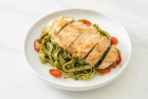 fettuccine spaghetti pasta in pesto sauce with grilled chicken photo