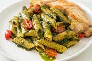 penne pasta in pesto sauce with grilled chicken photo