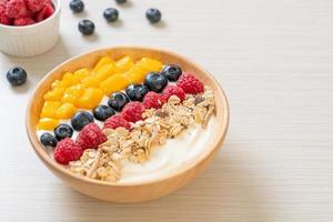 homemade yogurt bowl with raspberry, blueberry, mango and granola photo