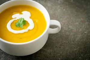 pumpkin soup in white bowl photo