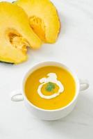 pumpkin soup in white bowl photo