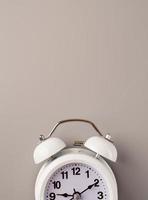 White retro alarm clock isolated on gray background with copy space photo