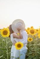 Beautiful couple having fun in sunflowers fields photo