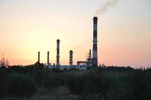 Panorama of a smoking chimney of a factory photo