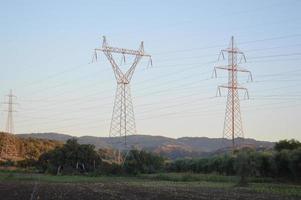 Poles and wires of high-voltage power lines photo