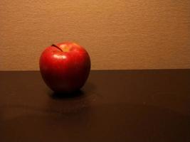 Closeup photo of apples on a table on an orange background