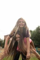 Two girls laugh and spin - carefree and fun time and friendship