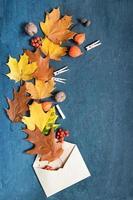 Flat lay autumn orange leaves and physalis on a dark background photo