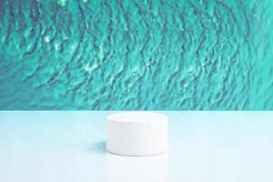 Empty podium or pedestal Mock-up for cosmetic production on a turquoise water background photo