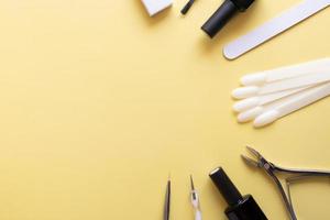 Manicure tools and tips on a colored background with copy space photo