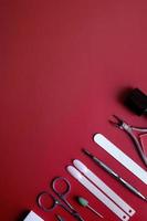 Manicure tools and tips on red background with copy space photo