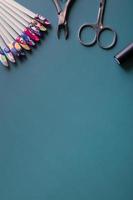 Manicure tools and tips on a colored background with copy space photo