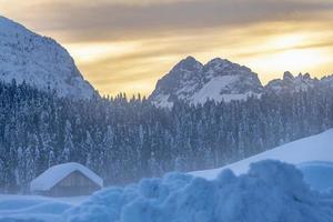 After the snowfall. Last lights of the twilight in Sappada. Magic of the Dolomites