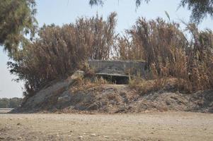 Reinforced concrete pillbox on the shores of the Aegean Sea of Rhodes photo