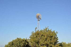 Windmill for generating electricity in the fields of Rhodes in Greece photo