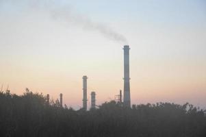 Panorama of a smoking chimney of a factory photo