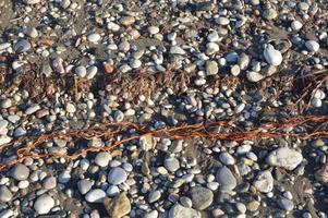Textura de guijarros en la costa egea en Grecia foto