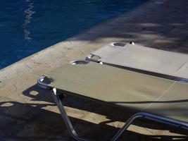 Sunbeds stand by the pool photo