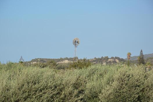 Windmill for generating electricity in the fields of Rhodes in Greece photo