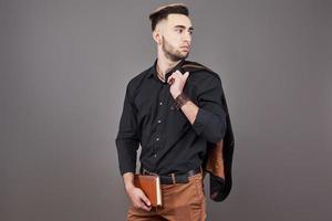 Portrait of toothy handsome bearded man with book on hands photo