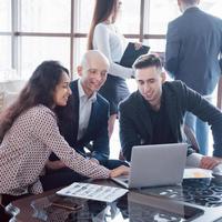 Young team of coworkers making great business discussion in modern coworking office. Teamwork people concept photo