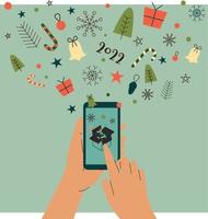 Human hand holding a mobile phone with Christmas elements fly out of the screen vector