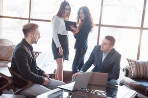 Two confident business man shaking hands during a meeting in the office, success, dealing, greeting and partner concept. photo