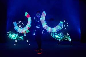 Laser show performance, dancers in led suits with LED lamp, very beautiful night club performance, party