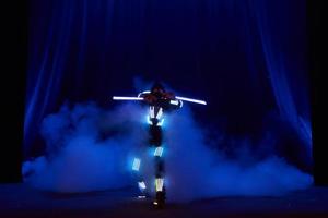 Laser show performance, dancers in led suits with LED lamp, very beautiful night club performance, party photo