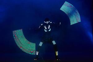 Laser show performance, dancers in led suits with LED lamp, very beautiful night club performance, party
