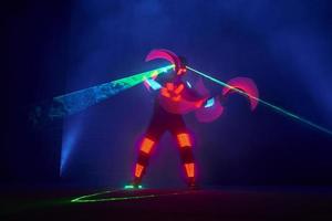 Laser show performance, dancers in led suits with LED lamp, very beautiful night club performance, party photo