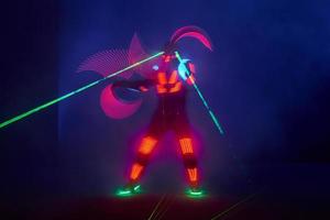 Laser show performance, dancers in led suits with LED lamp, very beautiful night club performance, party photo