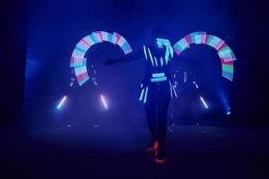 Laser show performance, dancers in led suits with LED lamp, very beautiful night club performance, party photo