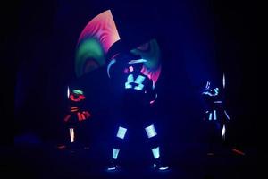 Laser show performance, dancers in led suits with LED lamp, very beautiful night club performance, party photo