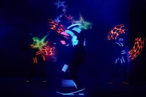 Laser show performance, dancers in led suits with LED lamp, very beautiful night club performance, party photo