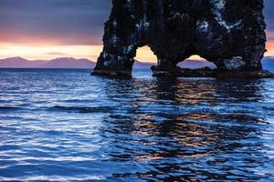 Hvitserkur is a spectacular rock in the sea on the Northern coast of Iceland. Legends say it is a petrified troll. On this photo Hvitserkur reflects in the sea water after the midnight sunset