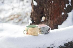 Two cups of tea on background of a winter landscape photo