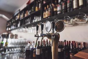 ready to pint of beer on a bar in a traditional style wooden pub photo