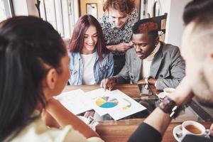 Group of casually dressed businesspeople discussing ideas. Creative professionals gathered for discuss the important issues of the new successful startup project. Teamwork Brainstorming Concept photo