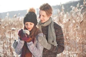 Couple has fun and laughs. kiss. Young hipster couple hugging each other in winter park. Winter love story, a beautiful stylish young couple. Winter fashion concept with boyfriend and girlfriend photo