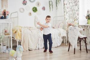 Little boy in white shirt with pillow. Pillow fight photo