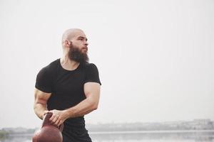The bearded young man is engaged in outdoor sports