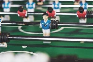 Table football in the entertainment center. Close-up image of plastic players in a football game photo