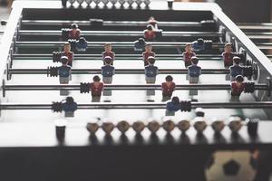 Table football in the entertainment center. Close-up image of plastic players in a football game photo