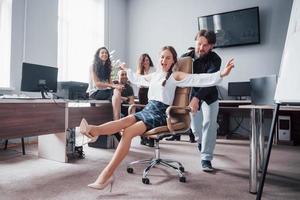 A group of business people celebrating, having fun, at the office. photo