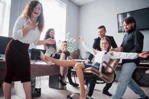 A group of business people celebrating, having fun, at the office. photo