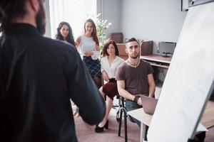 Group of young business people working and communicating together in creative office
