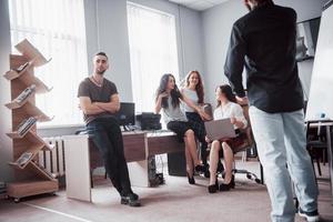 Successful business people are talking and smiling during in office. photo